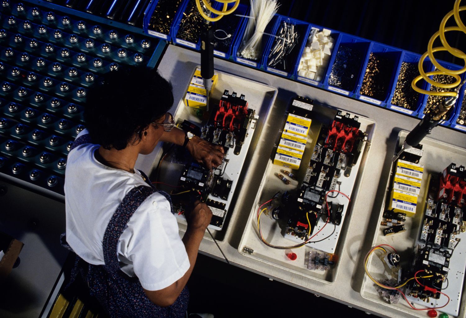 Electronics manufacturer sitting behind a desk working on a project.